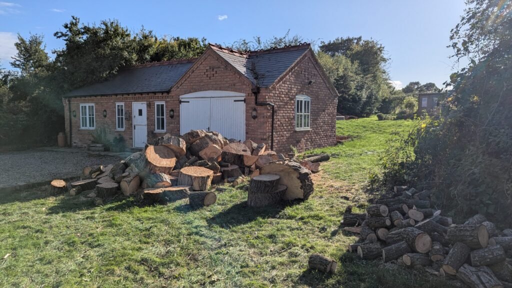 Log pile left for the customer's log burner after tree removal in Guilden Sutton